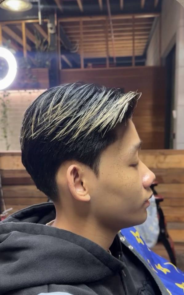 Textured haircut with blended sides at Tapper Don Barbershop